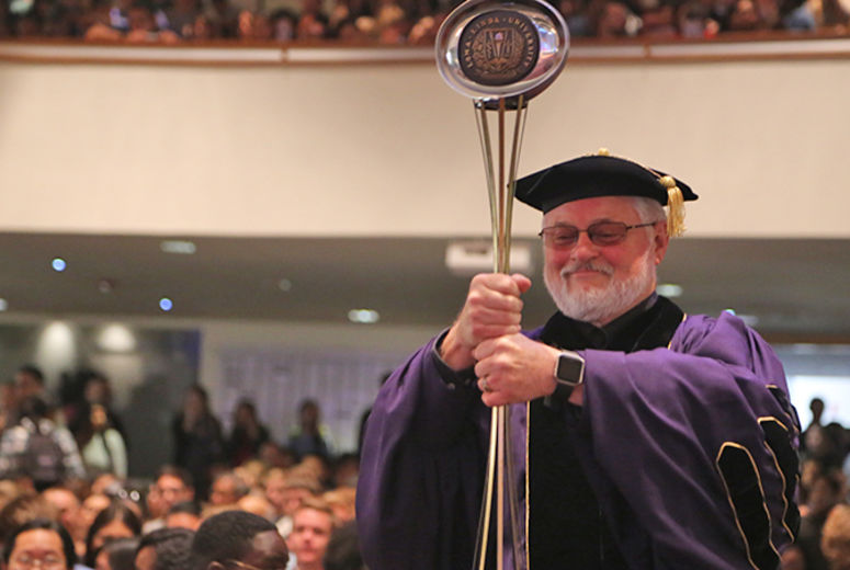 Provost Ron Carter, PhD, carries in the ceremonial mace.
