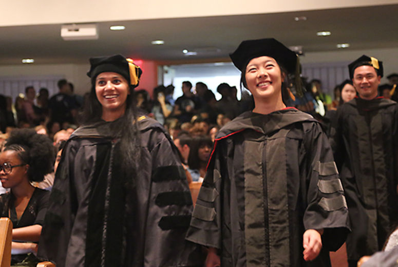 Faculty members in full regalia march in the opening processional.