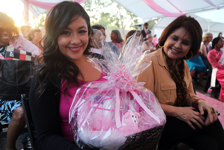 Nelly Fuentes smiles after winning a gift basket.