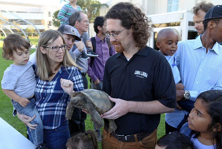 At the meet-and-greet, Eric Gren, PhD, introduced people to a Desert Tortoise.