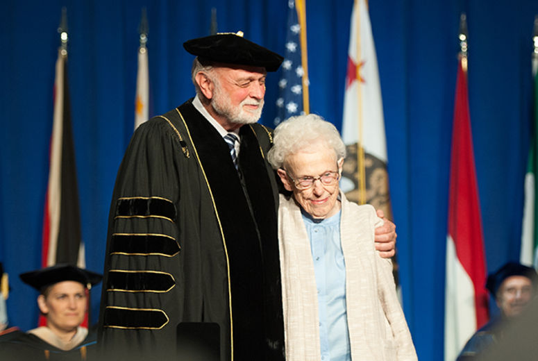  President Richard Hart, MD, DrPH, hugs legendary nurse Maxine Darling as she receives the Lifetime Service Award from the School of Nursing. 