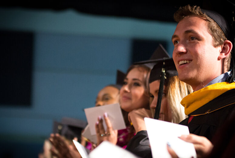 A graduate enjoys a moment during the ceremony for the Schools of Religion and Behavioral Health.