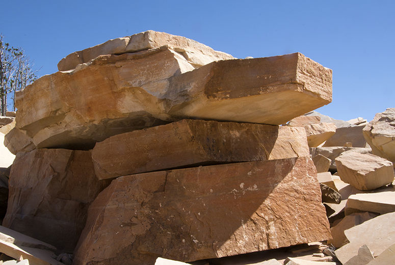 Thick slabs of Coconino Sandstone in a quarry near Ash Fork, Arizona, resemble a military tank. The stone is highly valued for use in homes, offices, and commercial spaces.