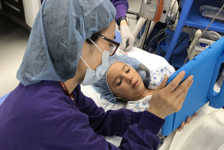 Nancy Wu works with a patient in Loma Linda University Children's Hospital.