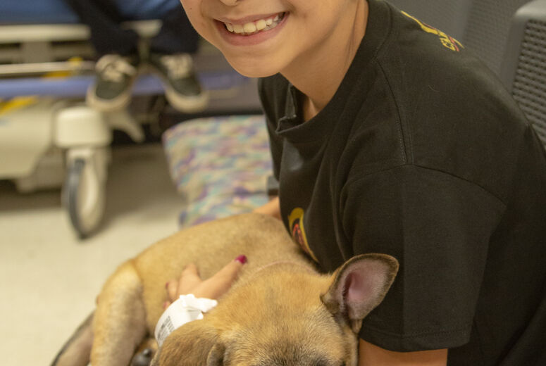  Caylee Cardenas, 9, from San Bernardino, cuddles up with one puppy.