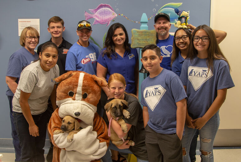 The group from Raising Cane's and YAPS visit the hemotology/oncology clinic.
