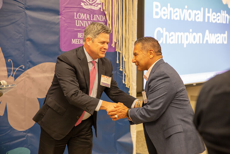 Edward Field, MBA, vice president for the Behavioral Medicine Center shakes hands with San Manuel Tribal Secretary Ken Ramirez.
