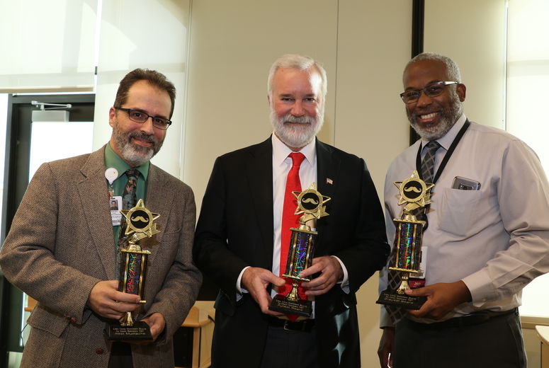 three men showing awards for No Shave LLUH