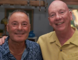 Don Staten standing smiling with his husband, Michael